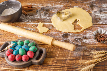 Still-life on a wooden background. Preparation for baking the curly cookies for Easter.