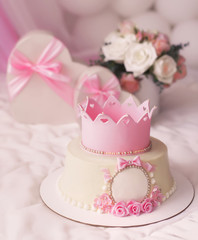 Pink cake with crown and gifts in heart box for pretty girl birthday party