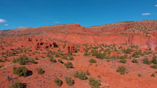 aerial shot flying around some beautiful red cliffs in the desert