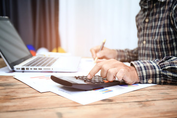 Businessman pen pointing graph chart for analyzing investment in his office