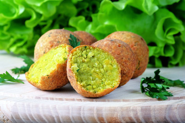 Falafel balls on a light cutting board. Vegan Middle Eastern food. Close-up view.