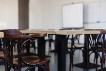 Inside the old classroom with blackboard, desks and chairs.