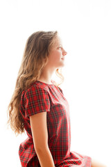 Cute teenager girl sitting near window