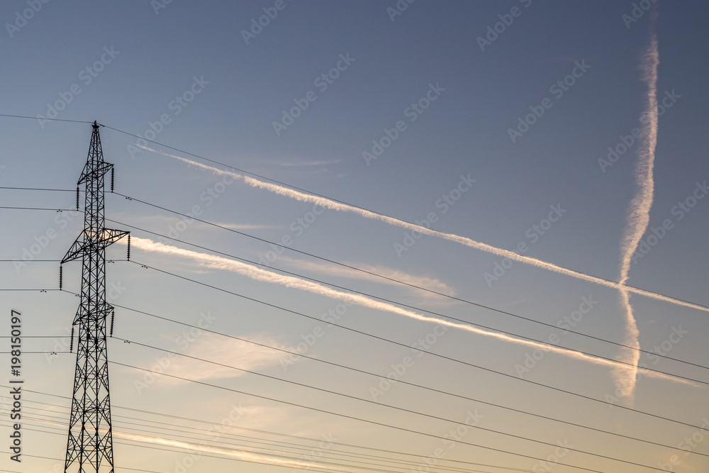 Wall mural parallel lines formed by airplane traces and transmission tower