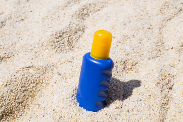 Summer holiday - suntan oil on beach