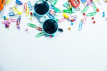 Obraz premium Top view of laptop, blank notebook, paper clips and smart phone with white background and copy space.