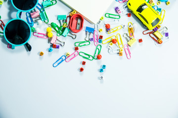 Top view of laptop, blank notebook, paper clips  and smart phone with white background and copy space.