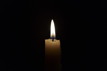 Candle flame closeup isolated on black. Abstract Background.
