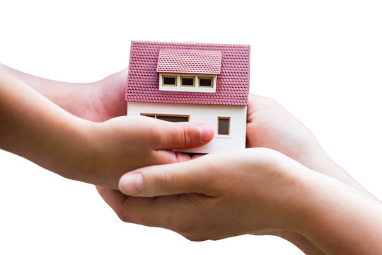 miniature house in hands