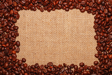 Frame on the background of a baggy cloth laid out of coffee beans in the form of a rectangle