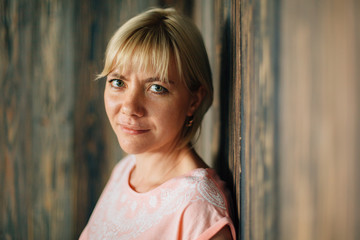 Young cute blonde woman in studio. Smiling girl with Bob haircut looking at camera