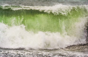 stormy weather at the black beach with high waves