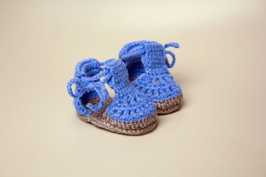 Blue Baby Booties Crochet on gray background
