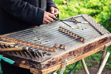 Cimbalom very special string wooden musical instrument. A street musician plays a cimbalom. The cimbalom, tambal, hammered dulcimer with player hands, hammers. Ukrainian national instrument folk music