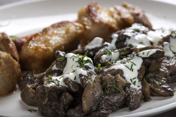Close up of mushrooms and sour cream on plate
