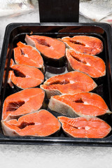 Fresh chilled salmon, red fish on the counter of the store