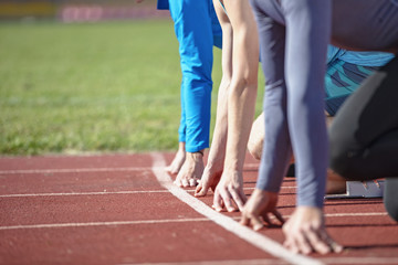 Athletes at the sprint start line in track and field
