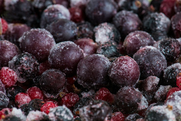 Close up of frozen mixed fruit - berries - red currant, cranberry, raspberry, blackberry, bilberry, blueberry, black currant