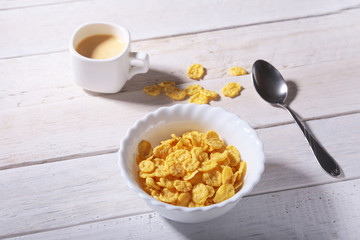 Corn Flakes cereal in a bowl and cap with espresso coffee. Morning breakfast.