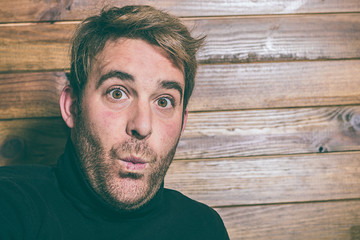 Portrait of a person whistling. Blond boy whistling. Social network style photo