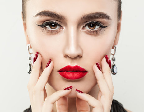 Perfect Female Face Closeup. Girl with Red Colorful Manicure and Makeup, Closeup Portrait