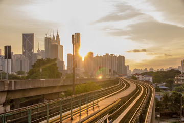 Sun rise brings a new day to the rapidly growing high tech city of Kuala Lumpur in Asia and is a good example of the regions booming economies and infrastructure - obrazy, fototapety, plakaty