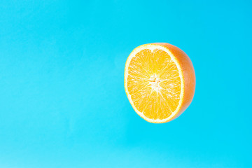 Ripe Juicy Halved Orange Floating Levitating in the Air on Light Blue Background. Vitamins Healthy...