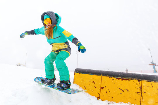 Young Snowboarder Jumping On Ramp.