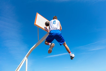 Young Basketball street player making slam dunk © FS-Stock
