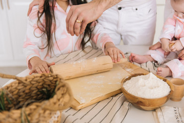 Close up view of bakers are working. Homemade bread. Hands preparing dough on wooden table.