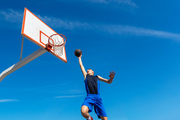 Young Basketball street player making slam dunk © FS-Stock