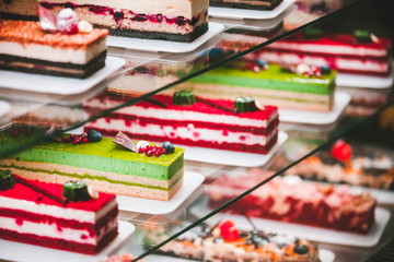 Showcase with different types of cakes in pastry shop