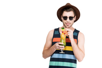 man in sunglasses and hat holding glass with cocktail, isolated on white