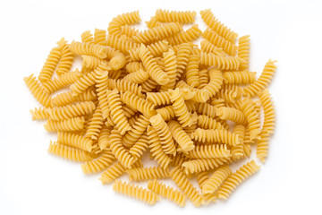 Uncooked fusilli pasta isolated white background.