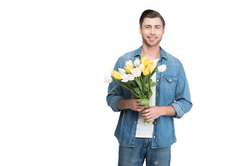 young man holding bouquet of spring tulips, isolated on white