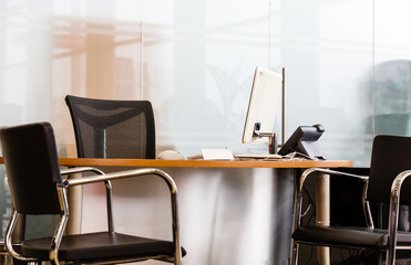 Workplace with notebook laptop Comfortable work table in office windows and city view.