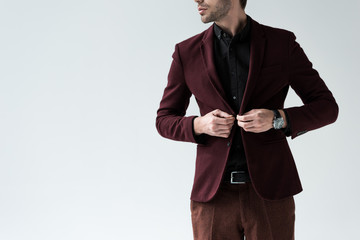 cropped view of stylish man posing in trendy suit, isolated on grey