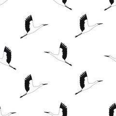 seamless pattern flying black and white storks on white isolated background