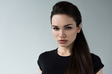 portrait of young beautiful brunette woman, isolated on grey