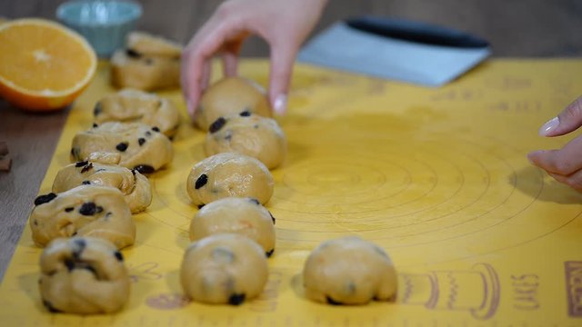Confectioners bakers cook dough for buns on bakery table