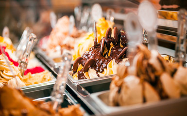 Ice cream in showcase fridge at pastry shop