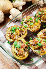 Baked potatoes in jacket stuffed with bacon, mushrooms and cheese. Dish served in baking dish..Baked potatoes stuffed with bacon, mushrooms and cheese