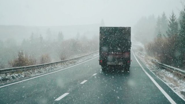 slow motion ride, dangerous car overtaking on highway at heavy snowy conditions. mountain, traffic situation, marks, Problems, truck, road train, trucking