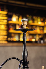 Hookah on the water stands on the bar with banks of tobacco with different tastes. Shisha Concept