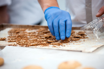Confectioner preparing cookies, confectionery industry