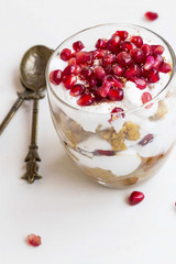 Cup dessert with cream and pomegranate fruits
