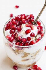 Cup dessert with cream and pomegranate fruits