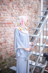 Hijab fashion portraiture.Beautiful muslim girl wearing traditional dress with hijab,outdoor shoot.