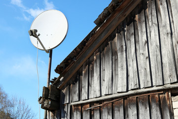 A modern satellite dish is fixed on the roof