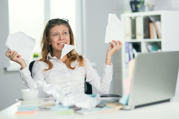 Beautiful tired and crazy mature businesswoman in glasses works
